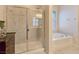 Relaxing bathroom featuring separate shower and tub with natural lighting at 6975 Hopi Summit Ct, Las Vegas, NV 89149