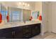Elegant bathroom with double sinks, granite countertops, and a shower-tub combo perfect for relaxation at 6975 Hopi Summit Ct, Las Vegas, NV 89149