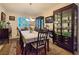 Dining room featuring table, chairs, carpet and two curios at 6975 Hopi Summit Ct, Las Vegas, NV 89149