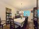 Dining room featuring table, chairs, carpet and two curios at 6975 Hopi Summit Ct, Las Vegas, NV 89149