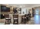 Spacious kitchen featuring a large island with seating, dark cabinets, and stainless steel appliances at 6975 Hopi Summit Ct, Las Vegas, NV 89149