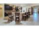 Spacious kitchen featuring a large island with seating, dark cabinets, and stainless steel appliances at 6975 Hopi Summit Ct, Las Vegas, NV 89149
