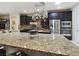 Close-up of the kitchen island showcasing granite countertops, stainless steel appliances, and ample workspace at 6975 Hopi Summit Ct, Las Vegas, NV 89149