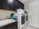 Efficient laundry room equipped with modern washer, dryer, and ample storage space at 6975 Hopi Summit Ct, Las Vegas, NV 89149