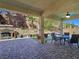 Inviting outdoor patio with stone pavers, fireplace, and comfortable seating area at 6975 Hopi Summit Ct, Las Vegas, NV 89149
