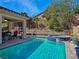 Relaxing backyard pool and spa with covered patio and desert landscaping are perfect for outdoor enjoyment at 6975 Hopi Summit Ct, Las Vegas, NV 89149