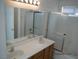 Bathroom featuring a double sink vanity, a large mirror, and a shower/tub combo with sliding doors at 7309 Sunspot Dr, Las Vegas, NV 89128
