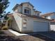 Two-story stucco home with a red tile roof, attached two-car garage, and well maintained landscaping at 7309 Sunspot Dr, Las Vegas, NV 89128