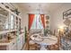 Cozy dining room featuring a round table, stylish decor, and a window with natural light at 7352 Rietz Canyon St, Las Vegas, NV 89131