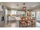 Bright kitchen with a large center island, pendant lighting, stainless steel appliances, and a farmhouse sink at 7352 Rietz Canyon St, Las Vegas, NV 89131