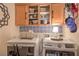 Organized laundry room with modern appliances, overhead cabinets, and stylish backsplash at 7352 Rietz Canyon St, Las Vegas, NV 89131