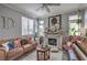 Cozy living room featuring a decorative fireplace, comfortable seating, and plenty of natural light at 7352 Rietz Canyon St, Las Vegas, NV 89131