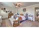 Spacious main bedroom with decorative furniture, neutral colors, and ample natural light at 7352 Rietz Canyon St, Las Vegas, NV 89131