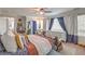 Bright and airy main bedroom with large windows, a ceiling fan, and an ensuite bathroom at 7352 Rietz Canyon St, Las Vegas, NV 89131