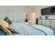 Comfortable bedroom with a soft color scheme, featuring dresser and access to bathroom at 7360 N Decatur Blvd # 1, Las Vegas, NV 89131