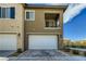 Two-story home featuring a two-car garage and a private balcony, set under a sunny sky at 7360 N Decatur Blvd # 1, Las Vegas, NV 89131