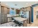 A spacious kitchen with stainless steel appliances, dark cabinetry, and a central island with seating at 7360 N Decatur Blvd # 1, Las Vegas, NV 89131