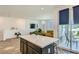 Kitchen island with quartz countertop in an open-concept living space with balcony access at 7360 N Decatur Blvd # 1, Las Vegas, NV 89131
