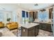 An open-concept kitchen flows into the living area, featuring a central island and modern appliances at 7360 N Decatur Blvd # 1, Las Vegas, NV 89131