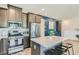 Modern kitchen with granite countertops, stainless appliances, and island seating at 7360 N Decatur Blvd # 1, Las Vegas, NV 89131