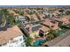 Aerial view of desert homes with Spanish tile roofs and solar panels in a Primary-planned community near the mountains at 7619 Belgian Lion St, Las Vegas, NV 89139