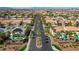 Aerial view of desert homes with Spanish tile roofs and solar panels in a Primary-planned community at 7619 Belgian Lion St, Las Vegas, NV 89139