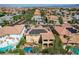 Aerial view of desert homes with Spanish tile roofs and solar panels in a Primary-planned community at 7619 Belgian Lion St, Las Vegas, NV 89139