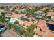 Aerial view of desert homes with Spanish tile roofs and solar panels in a Primary-planned community at 7619 Belgian Lion St, Las Vegas, NV 89139