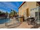 Backyard boasts a pool, spa, outdoor kitchen with bar seating, and a safety fence at 7619 Belgian Lion St, Las Vegas, NV 89139