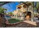 A stunning backyard featuring a private pool, rock waterfall, and outdoor patio at 7619 Belgian Lion St, Las Vegas, NV 89139