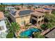 Backyard of desert home with tile roof, solar panels, covered patio, and a private swimming pool at 7619 Belgian Lion St, Las Vegas, NV 89139