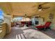 Inviting covered balcony with ceiling fans and comfortable lounge furniture for outdoor relaxation at 7619 Belgian Lion St, Las Vegas, NV 89139
