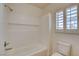 Bright bathroom with a soaking tub, tile surround, and plantation shutters at 7619 Belgian Lion St, Las Vegas, NV 89139