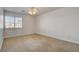 Well-lit bedroom with neutral carpet, a ceiling fan, and bright window at 7619 Belgian Lion St, Las Vegas, NV 89139