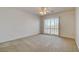 Bedroom featuring neutral carpet, a ceiling fan, and access to a balcony at 7619 Belgian Lion St, Las Vegas, NV 89139