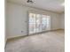 Bedroom with neutral carpet and sliding glass door to the backyard patio at 7619 Belgian Lion St, Las Vegas, NV 89139