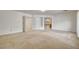 Spacious primary bedroom with plush carpet and attached bathroom through a large doorway at 7619 Belgian Lion St, Las Vegas, NV 89139