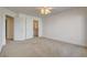 Bedroom features neutral carpet, a ceiling fan, and access to a closet at 7619 Belgian Lion St, Las Vegas, NV 89139