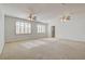 Large bonus room with plantation shutters, dual ceiling fans, and neutral carpet at 7619 Belgian Lion St, Las Vegas, NV 89139