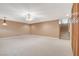 Neutral bonus room with carpet, built-in cabinets, a ceiling fan, and stairs to the upper level at 7619 Belgian Lion St, Las Vegas, NV 89139
