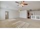 Bright bonus room with neutral carpet, two ceiling fans, and access to the bathroom at 7619 Belgian Lion St, Las Vegas, NV 89139