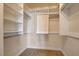 Walk-in closet with neutral carpet and built-in shelves at 7619 Belgian Lion St, Las Vegas, NV 89139