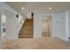 Bright entryway with a staircase, tile flooring, and arched doorways leading to other rooms at 7619 Belgian Lion St, Las Vegas, NV 89139