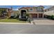 Charming two-story home featuring a red tile roof, desert landscaping, and a three-car garage at 7619 Belgian Lion St, Las Vegas, NV 89139