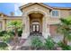 Inviting front entry with double doors, stone pathway, and desert landscaping at 7619 Belgian Lion St, Las Vegas, NV 89139