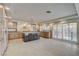 Spacious kitchen featuring tile flooring, a large island, custom cabinets, and access to the backyard at 7619 Belgian Lion St, Las Vegas, NV 89139