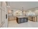 Bright kitchen with a large island, granite counters, stainless appliances, and neutral colored cabinets at 7619 Belgian Lion St, Las Vegas, NV 89139