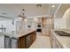 Bright kitchen featuring a large island with granite countertops, built in appliances, and stainless steel gas cooktop at 7619 Belgian Lion St, Las Vegas, NV 89139