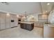 Bright kitchen with stainless steel appliances, granite countertops, tile flooring, and a large island at 7619 Belgian Lion St, Las Vegas, NV 89139