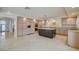 Well-lit kitchen featuring an island with dark cabinets and granite countertops and stainless steel appliances at 7619 Belgian Lion St, Las Vegas, NV 89139